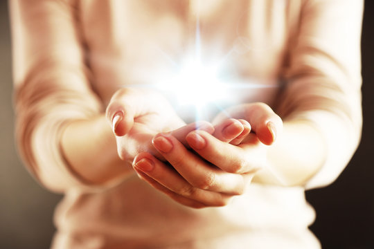 Light in hands.  Concept of taking, care, protection