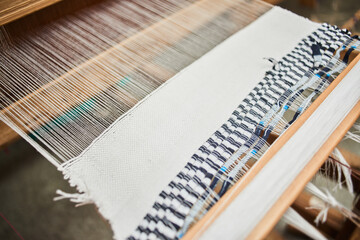 The production process of the handmade textiles on the loom