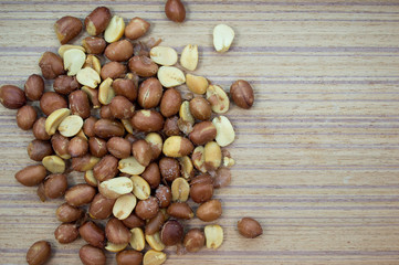 Salted peanuts on a wooden background.