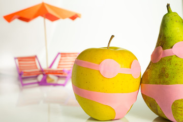 apple and pear in a bathing suit