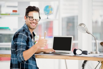 Young man showing thumbs up