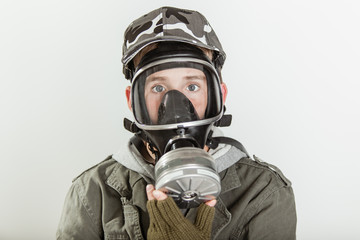 Male teen with face covered by respirator