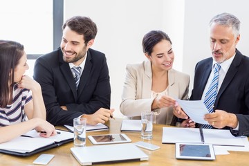 Workers are talking to each other and smiling