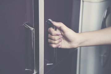 woman hand in cupboard