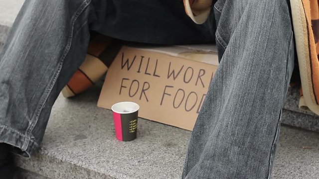 Starving homeless man eating canned food and asking for help, destitution