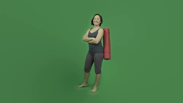 caucasian sporty girl with yoga mat isolated on green screen confident smiling