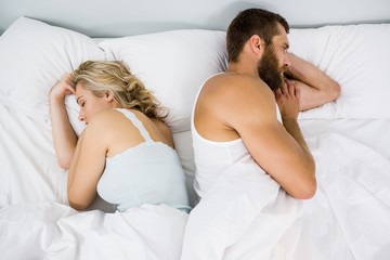 Couple sleeping on bed