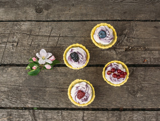 Blueberry  cupcakes with berries  and apple flowers on the wooden old planks