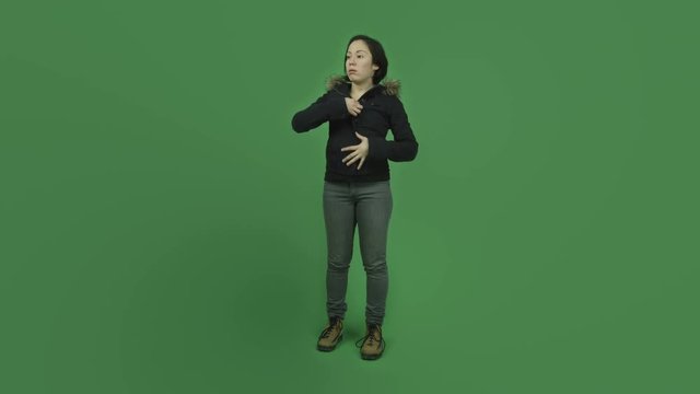 caucasian girl with winter jacket isolated on green screen warm undressing