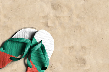 Fototapeta na wymiar Thongs with flag of Bulgaria, on beach sand