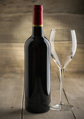 Bottle of dry red wine with a glass