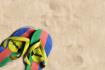 Thongs with flag of New Caledonia, on beach sand
