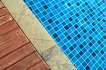 Wooden and marble floor beside swimming pool