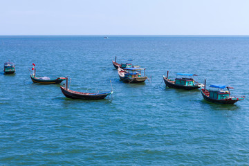  Fishing village with wooden boat berth at seashore and coracle float on water in Hai Hau, Viet Nam