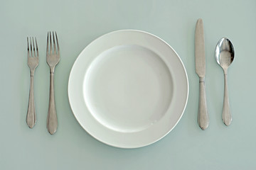 spoon fork  knife and empty white plate