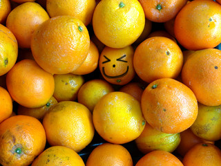 Bunch of fresh oranges background with smile