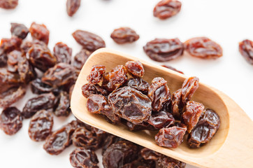 Dried raisins on white background.