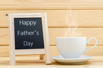 Happy father's day in chalkboard with a cup of coffee.