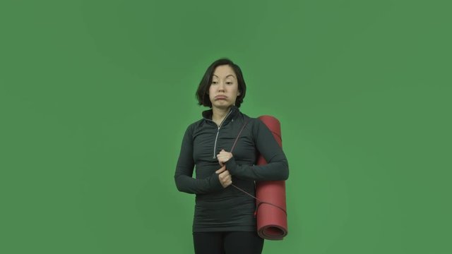 caucasian sporty girl isolated on green screen sad with yoga mat