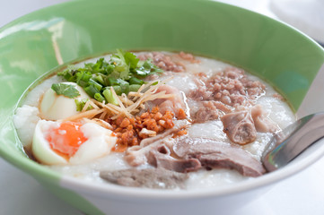 Rice porridge, rice gruel, congee rice soup with egg and pork