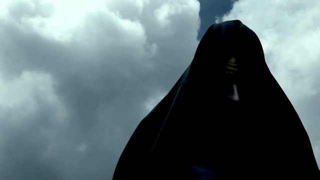 Appearance of a hooded man in black robe

