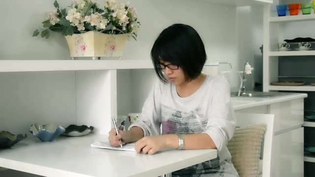 An Asian Thai girl writing something on the paper and screw up with sulky temper in HD 