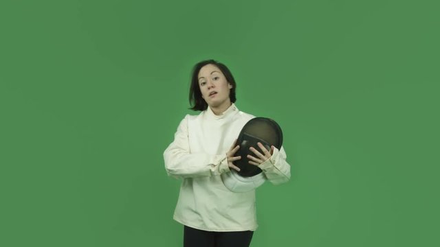 caucasian fencing with sword girl isolated on green screen silence with secret