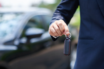 Close-up image of man giving you keys of his car