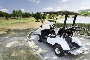 Golf cart over nice green and blue sky