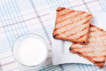 Obraz na płótnie Canvas tasty toast with milk on the table