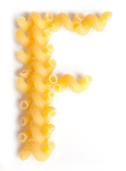 Letter F made from macaroni under a daylight isolated on white background