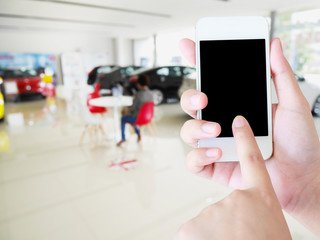 woman hands holding mobile phone with blurred background of new