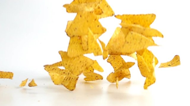 Falling Nachos against white background. Shot with high speed camera in slow motion.