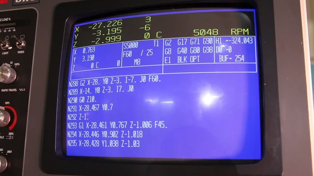 CNC machine monitor display with program code running
