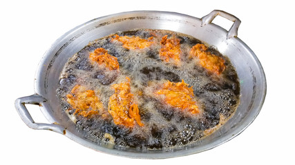Chicken fried in a pan of boiling oil