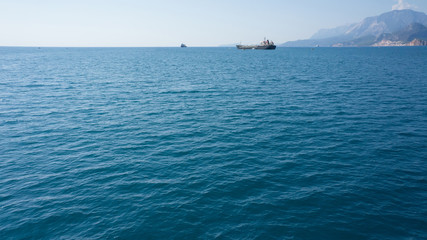 Blue sea with ships on horizon