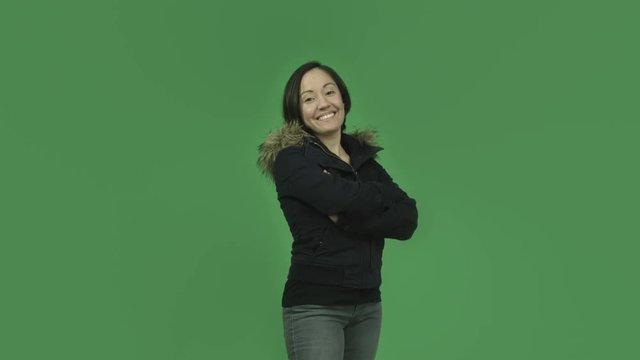 caucasian girl with winter jacket isolated on green screen smiling