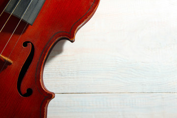 violin on wooden brown background closeup