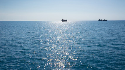 Blue sea with ships on horizon