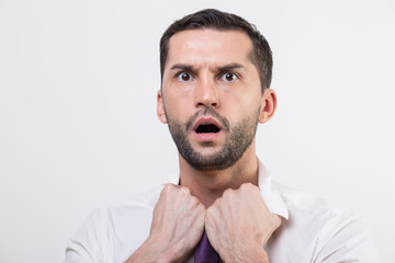 Obraz premium Exhausted young businessman loosening tie