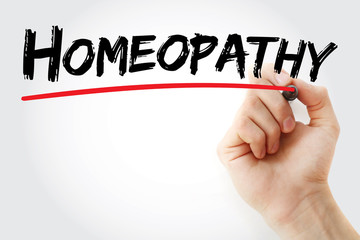 Hand writing Homeopathy with marker, health concept background