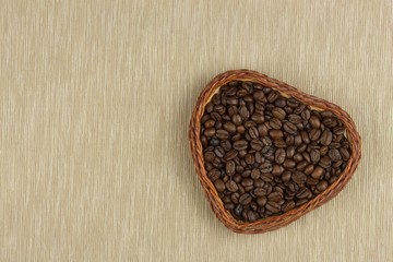 Roasted coffee beans on the kitchen table. Fresh coffee. Preparation of hot coffee. Refreshing drink. Sales of coffee beans. Advertising for coffee shop. We love fresh coffee.
