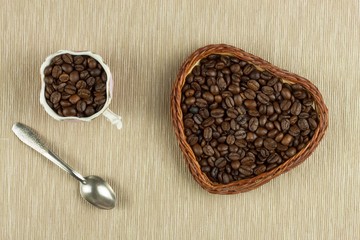 Roasted coffee beans on the kitchen table. Fresh coffee. Preparation of hot coffee. Refreshing drink. Sales of coffee beans. Advertising for coffee shop. We love fresh coffee.
