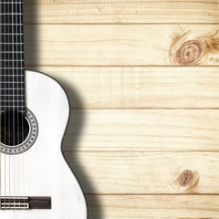 Obraz premium White classical guitar on vintage wood background with copy space.