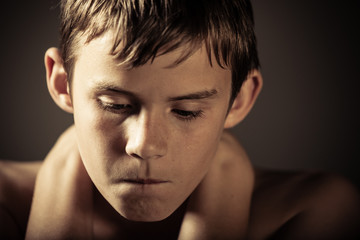 Angry Teenage Boy with Hands Holding Neck