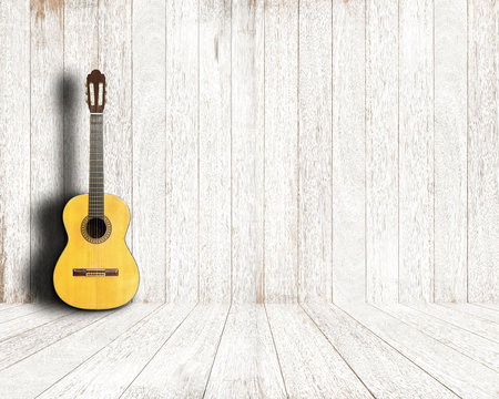 Classical guitar in vintage white wood room.