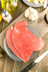 vertical making of raw beef fillet on plate