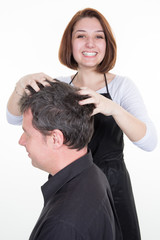 Male getting a massage while having hair cut at salon by hairdresser