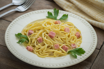 Spaghetti carbonara with ham on plate