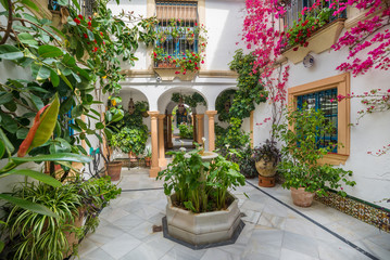 Beautiful formal garden decorated with flowers in spring festival, Cordoba, Spain
